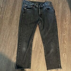 Levi’s Jeans  501 Tapered Black Wash Jeans with Frayed hem. Metal Button Down.